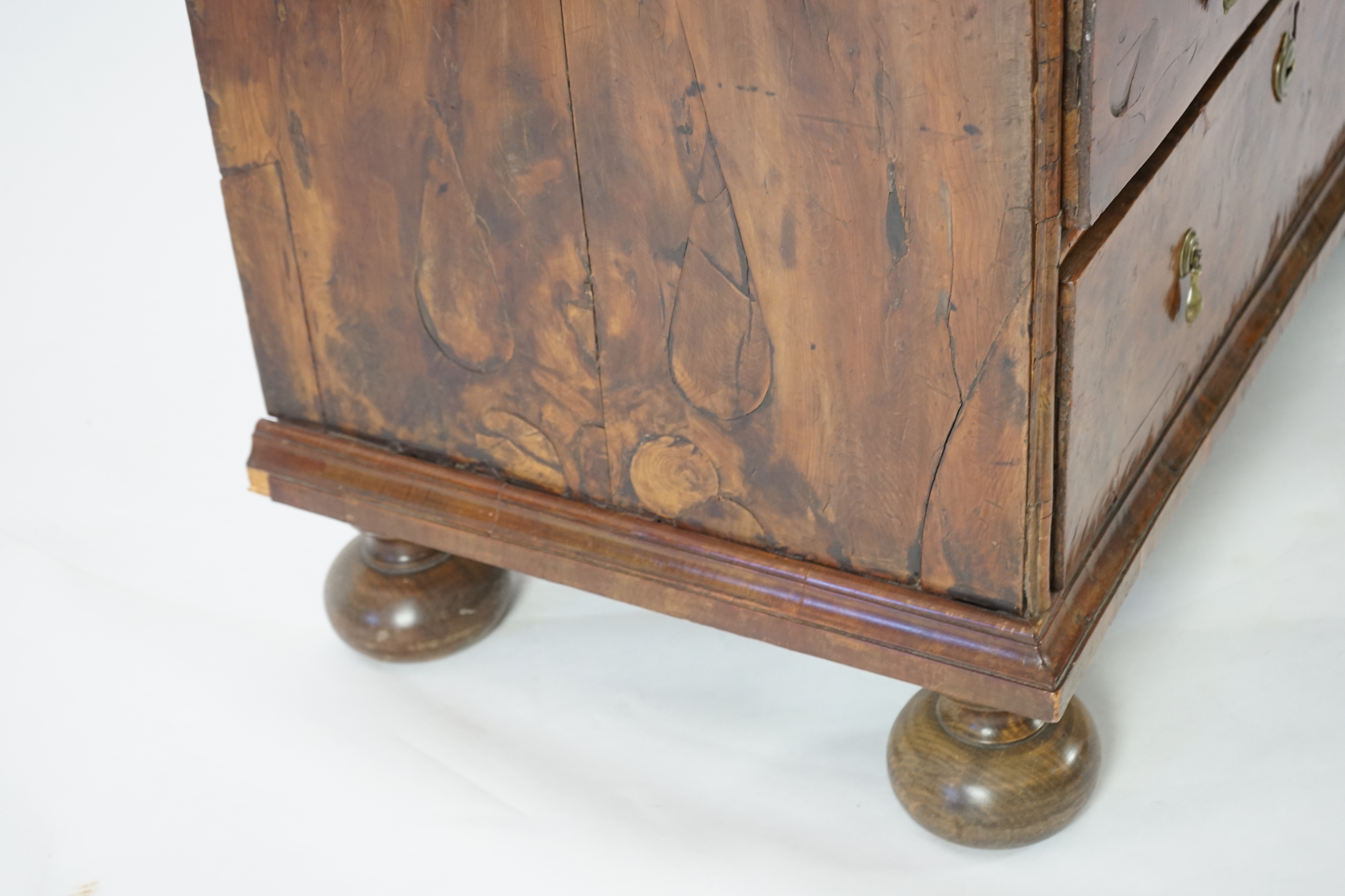 An early 18th century and later yew wood veneered oak chest